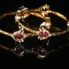 Pink lotus 2pc bangles with floral design and gold finish by nischala fashions