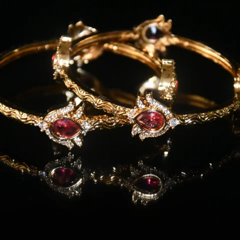 Pink lotus 2pc bangles with floral design and gold finish by nischala fashions