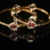 Pink lotus 2pc bangles with floral design and gold finish by nischala fashions