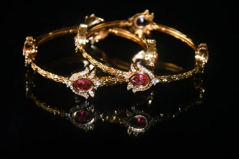 Pink lotus 2pc bangles with floral design and gold finish by nischala fashions