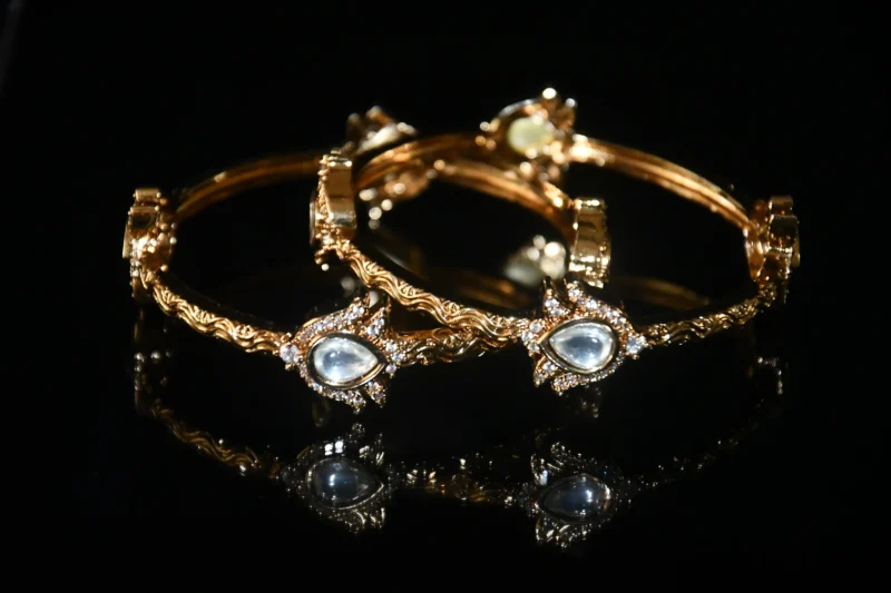 White lotus 2pc bangles with gold finish and floral detailing by nischala fashions