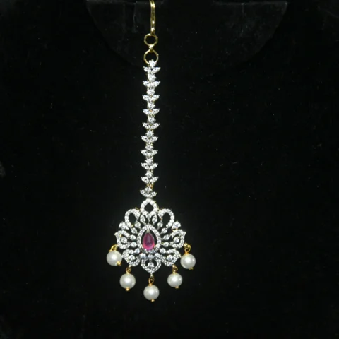 Diamond Pink Maang Tikka with CZ stones, pink enamel, and pearl hanging in traditional design by nischala fashions