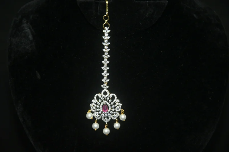Diamond Pink Maang Tikka with CZ stones, pink enamel, and pearl hanging in traditional design by nischala fashions