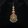 Jadau kundan Lakshmi maang tikka with green beads hanging, divine Indian accessory by Nischala Fashions.