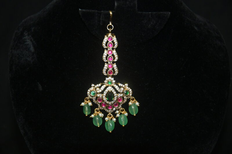 Jadau kundan maang tikka with green beads hanging, regal traditional jewelry by Nischala Fashions.
