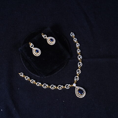 Simple diamond necklace with earrings in blue, featuring sparkling stones and elegant design by Nischala Fashions.