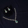 Simple diamond necklace with earrings in green, adorned with shimmering diamonds and lush green stones by Nischala Fashions.