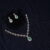 Simple diamond necklace with earrings in green, adorned with shimmering diamonds and lush green stones by Nischala Fashions.