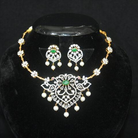 Diamond green kante necklace with earrings, traditional kante design with green stones and diamonds by Nischala Fashions.