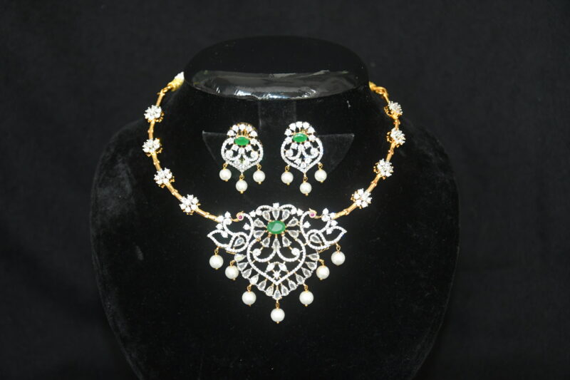 Diamond green kante necklace with earrings, traditional kante design with green stones and diamonds by Nischala Fashions.