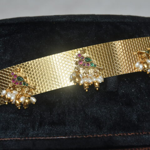 Plain antique waistbelt with Kempu peacock pendant and pearl cluster hanging by Nischala Fashions